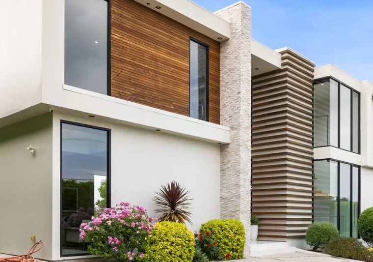 A Driveway of a contemporary house with a garden area