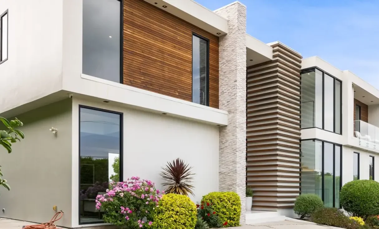 A Driveway of a contemporary house with a garden area