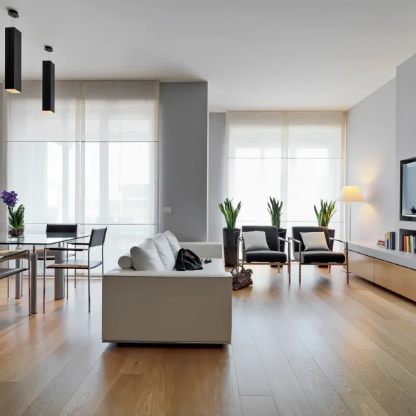 interiros shots of a modern living room in the foreground the leather sofa and the glass dining table the floor is made of wood